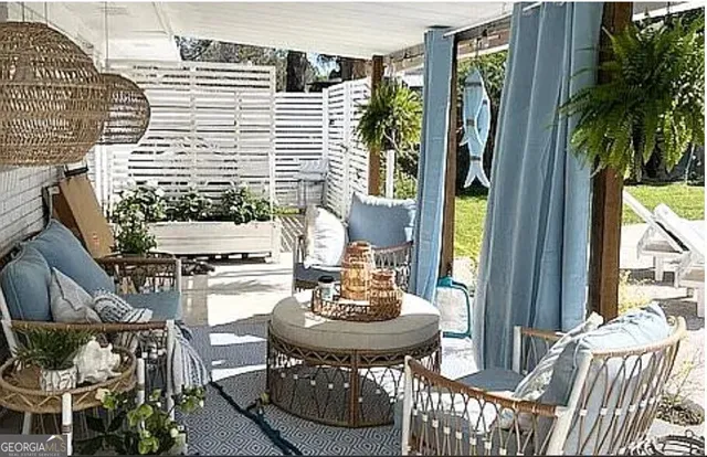 a view of a patio with table and chairs and potted plants