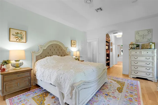 a view of a hallway with wooden floor and closet