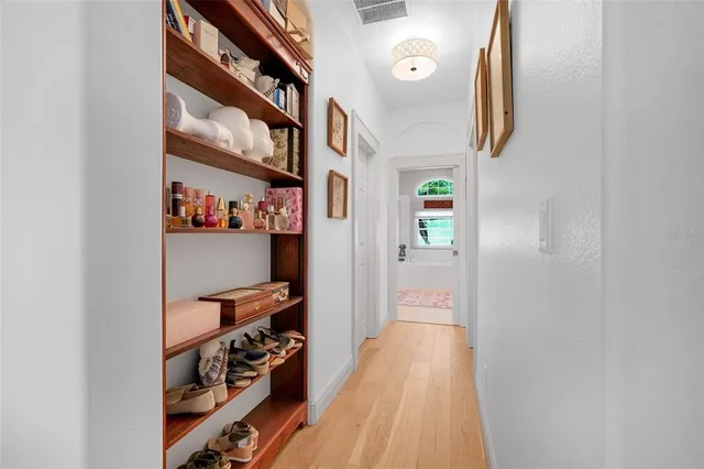a view of walk in closet with clothes