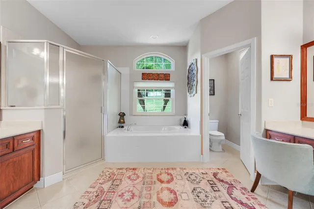 a spacious bathroom with a granite countertop sink and a mirror