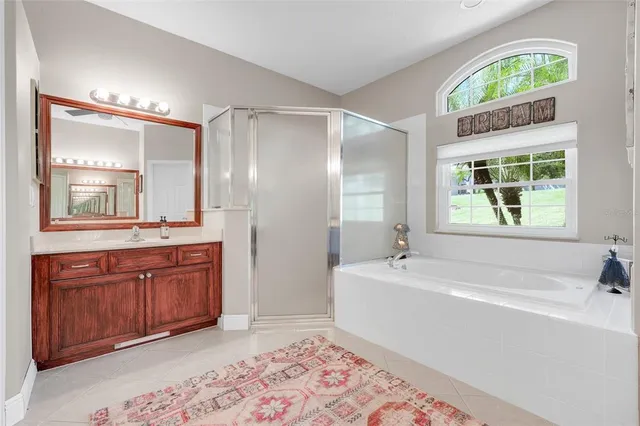 a large kitchen with stainless steel appliances a stove a sink a refrigerator and a cabinets