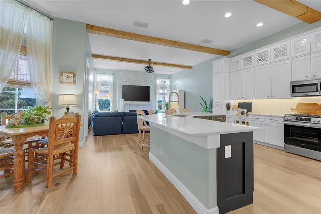 a dining room with furniture and wooden floor