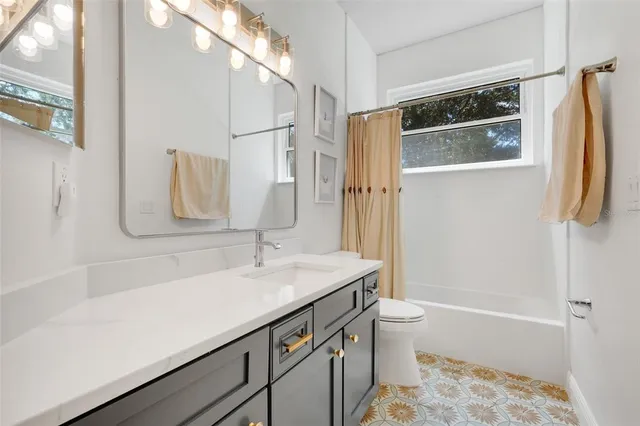 a bedroom with furniture and a large window