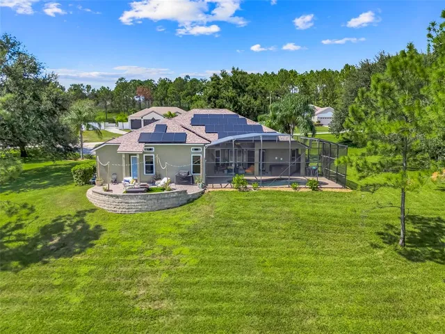 a view of a backyard with a garden and entertaining space