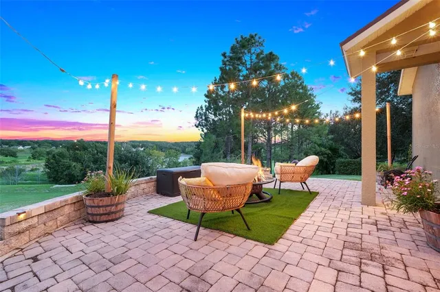 a view of a chairs and table in backyard