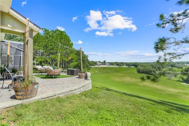 a view of a patio with table and chairs under an umbrella