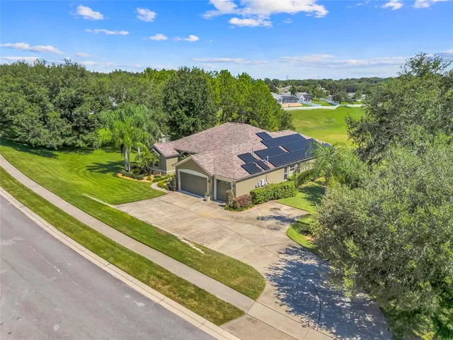 an aerial view of residential houses with outdoor space and swimming pool