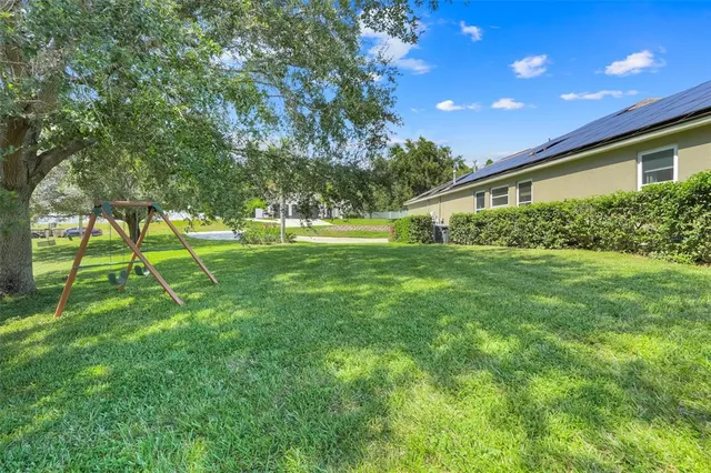 an aerial view of lake with residential house and outdoor space