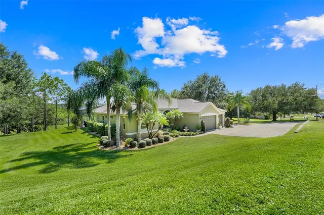 a aerial view of a houses with a yard