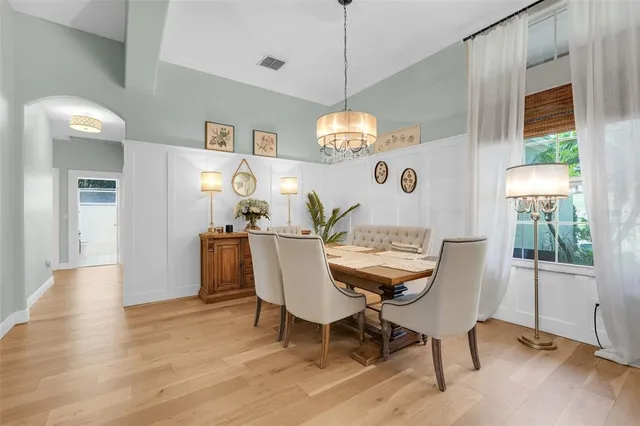 a view of a dining room with furniture and chandelier
