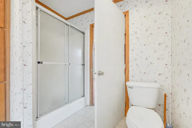 a white toilet sitting next to a bathroom sink