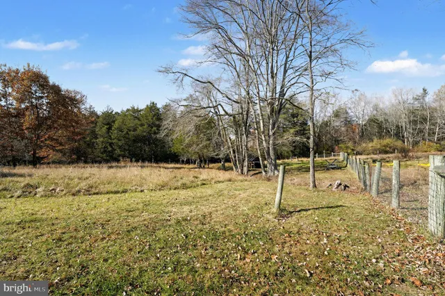 a backyard of a house with lots of green space and lake view