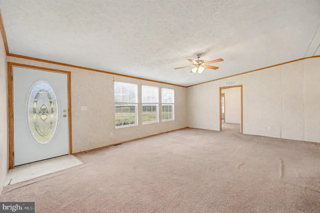 an empty room with windows and closet