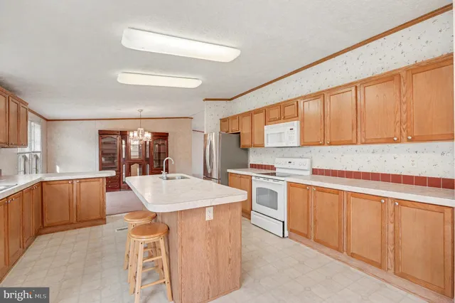 a large kitchen with stainless steel appliances granite countertop a sink and cabinets