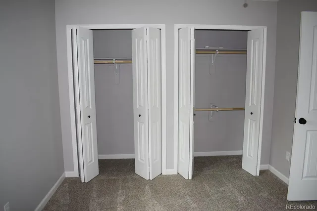a view of an empty room with closet area