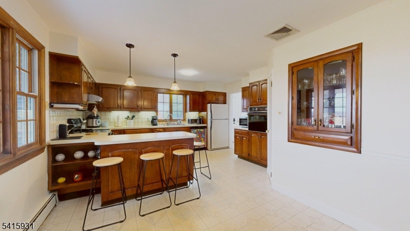 168 Line Road West Windsor, NJ 08550 - Photo 4 of 19 a kitchen with stainless steel appliances granite countertop a refrigerator a sink a stove and white cabinets