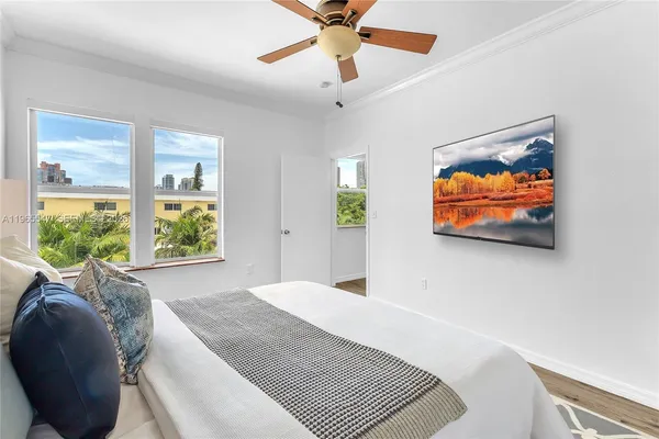 a bedroom with a bed and a painting on the wall