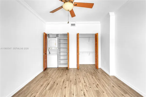a view of a room with wooden floor ceiling fan
