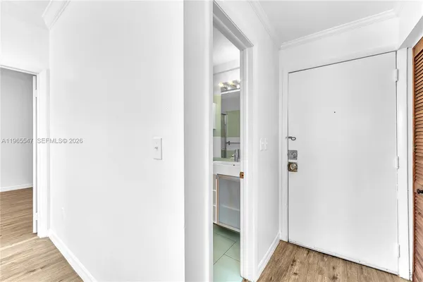 a view of a hallway with wooden floor