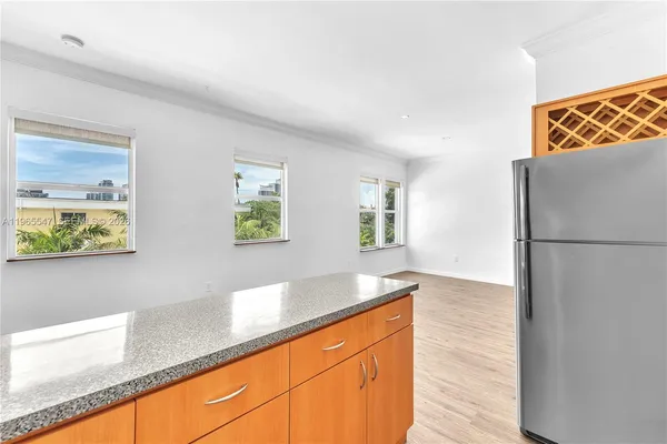 a kitchen with stainless steel appliances granite countertop a refrigerator and a sink