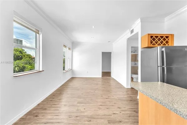 a view of a kitchen with a sink and a window