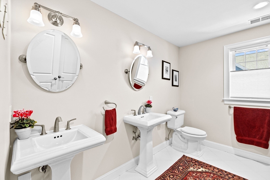 38 Gilson Road Scituate, MA 02066 - Photo 24 of 42 a bathroom with a sink mirror and toilet
