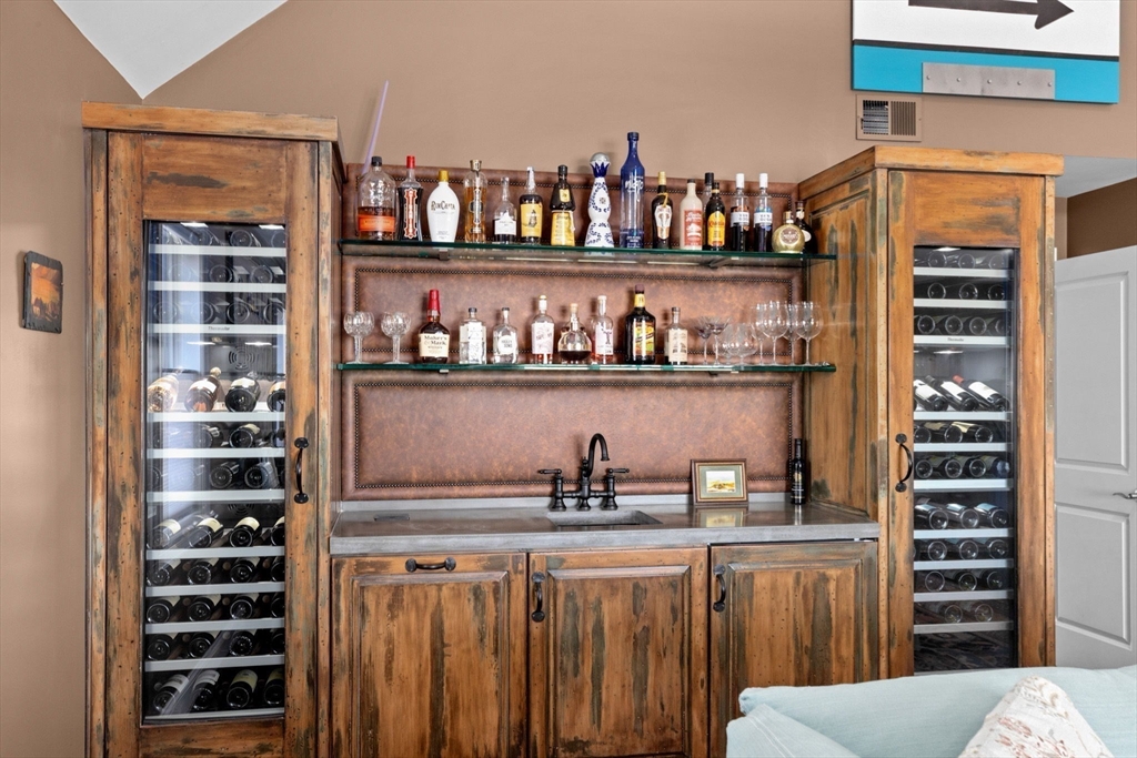 38 Gilson Road Scituate, MA 02066 - Photo 30 of 42 a kitchen with stainless steel appliances a shelf and a refrigerator