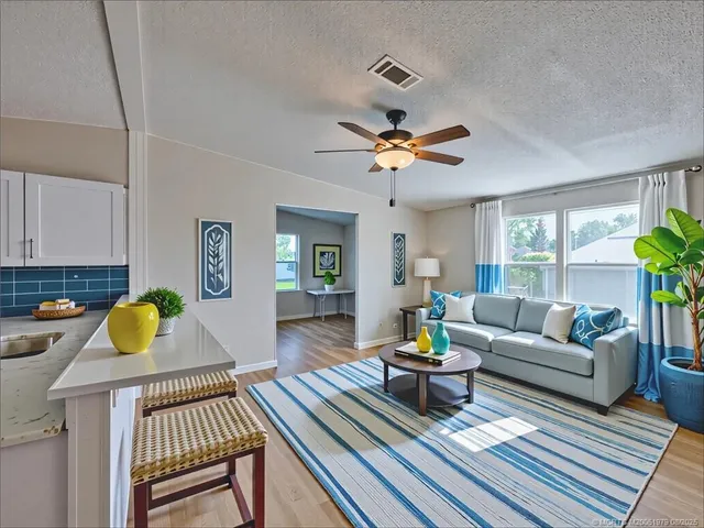 a living room with furniture a rug and a chandelier