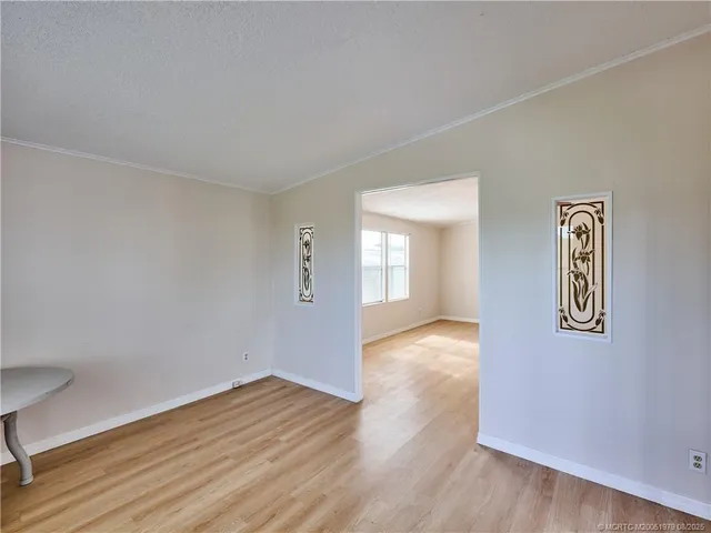 a view of a room with wooden floor and window