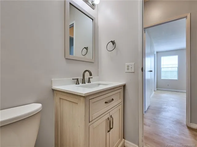 a bathroom with a sink a toilet and mirror