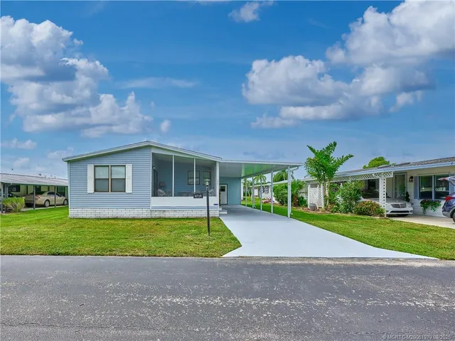 a view of a house with a swimming pool and a yard