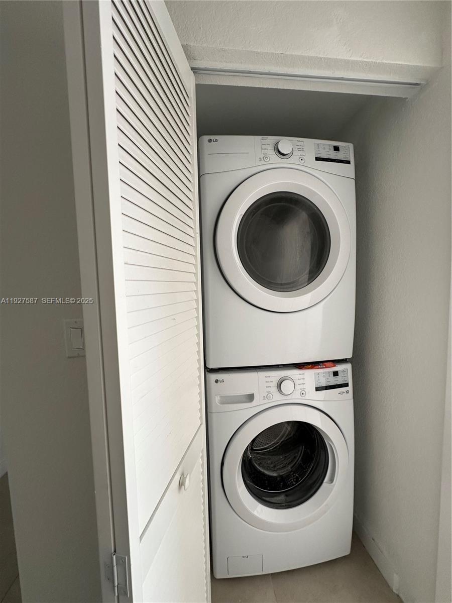 14573 Southwest 261st Terrace, Unit 14573 Homestead, FL 33032 - Photo 18 of 35 a utility room with dryer and washer