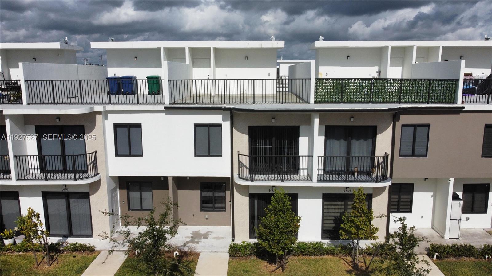 14573 Southwest 261st Terrace, Unit 14573 Homestead, FL 33032 - Photo 2 of 35 a front view of a multi story building