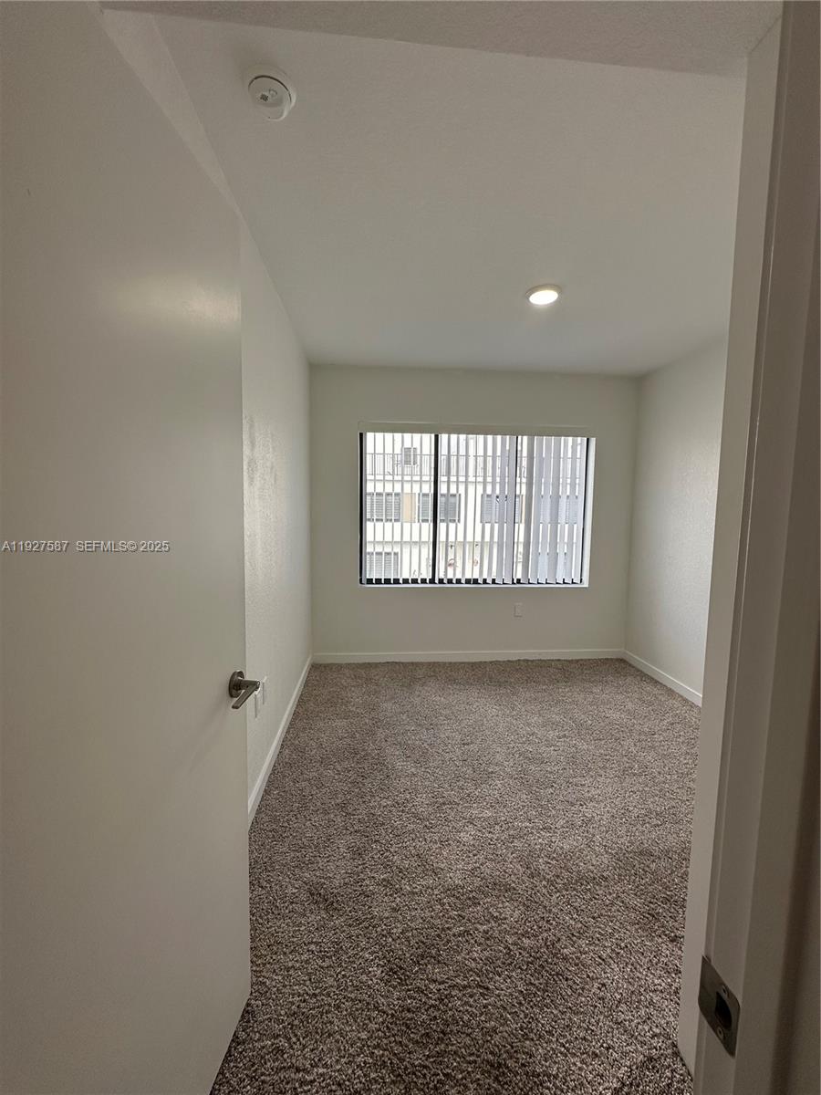 14573 Southwest 261st Terrace, Unit 14573 Homestead, FL 33032 - Photo 24 of 35 a view of hallway with a window