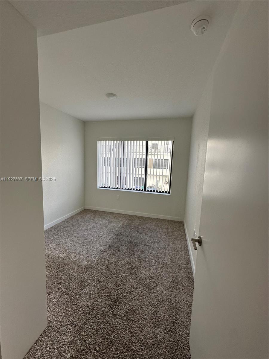14573 Southwest 261st Terrace, Unit 14573 Homestead, FL 33032 - Photo 26 of 35 a view of an empty room with a window