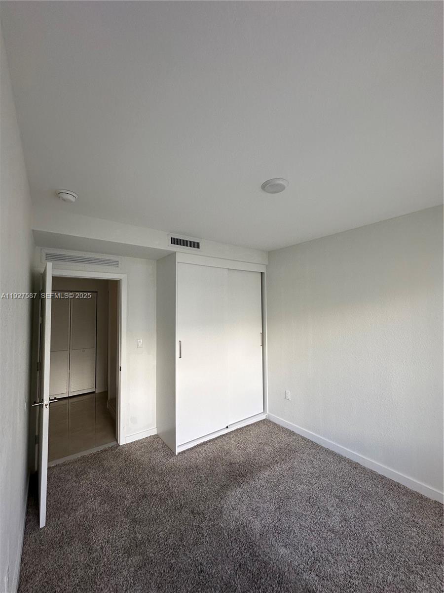 14573 Southwest 261st Terrace, Unit 14573 Homestead, FL 33032 - Photo 27 of 35 a view of an empty room and closet area