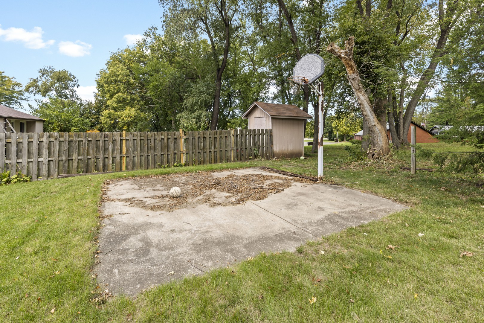 3626 Toft Street Rockford, IL 61114 - Photo 22 of 22 a view of a backyard with large trees and wooden fence