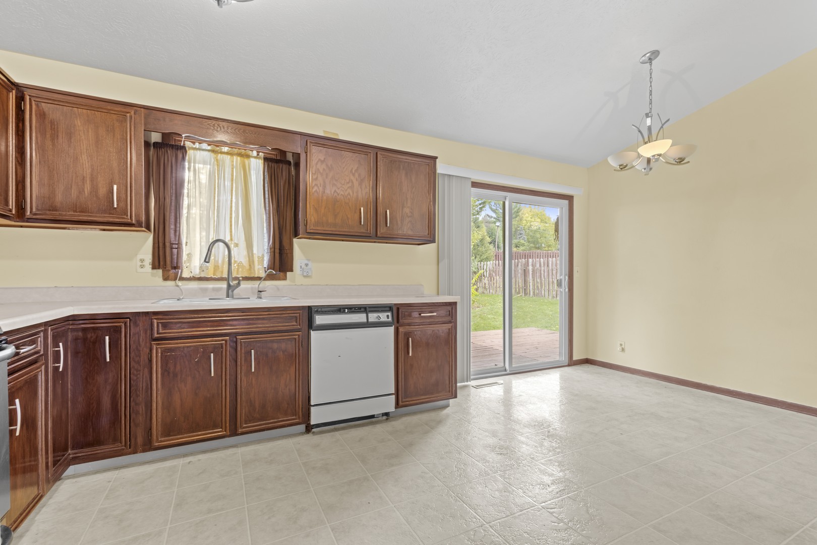 3626 Toft Street Rockford, IL 61114 - Photo 6 of 22 a kitchen with stainless steel appliances granite countertop a stove a sink and a refrigerator with wooden cabinets