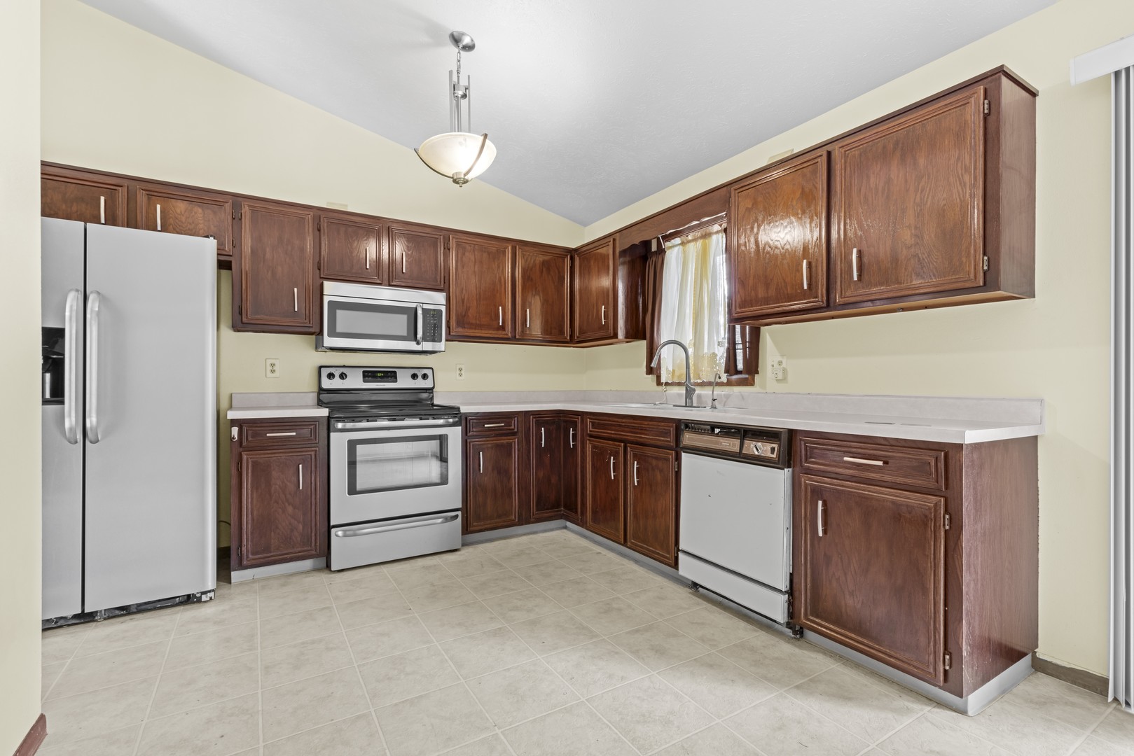 3626 Toft Street Rockford, IL 61114 - Photo 7 of 22 a kitchen with stainless steel appliances granite countertop a refrigerator a stove top oven a sink and dishwasher