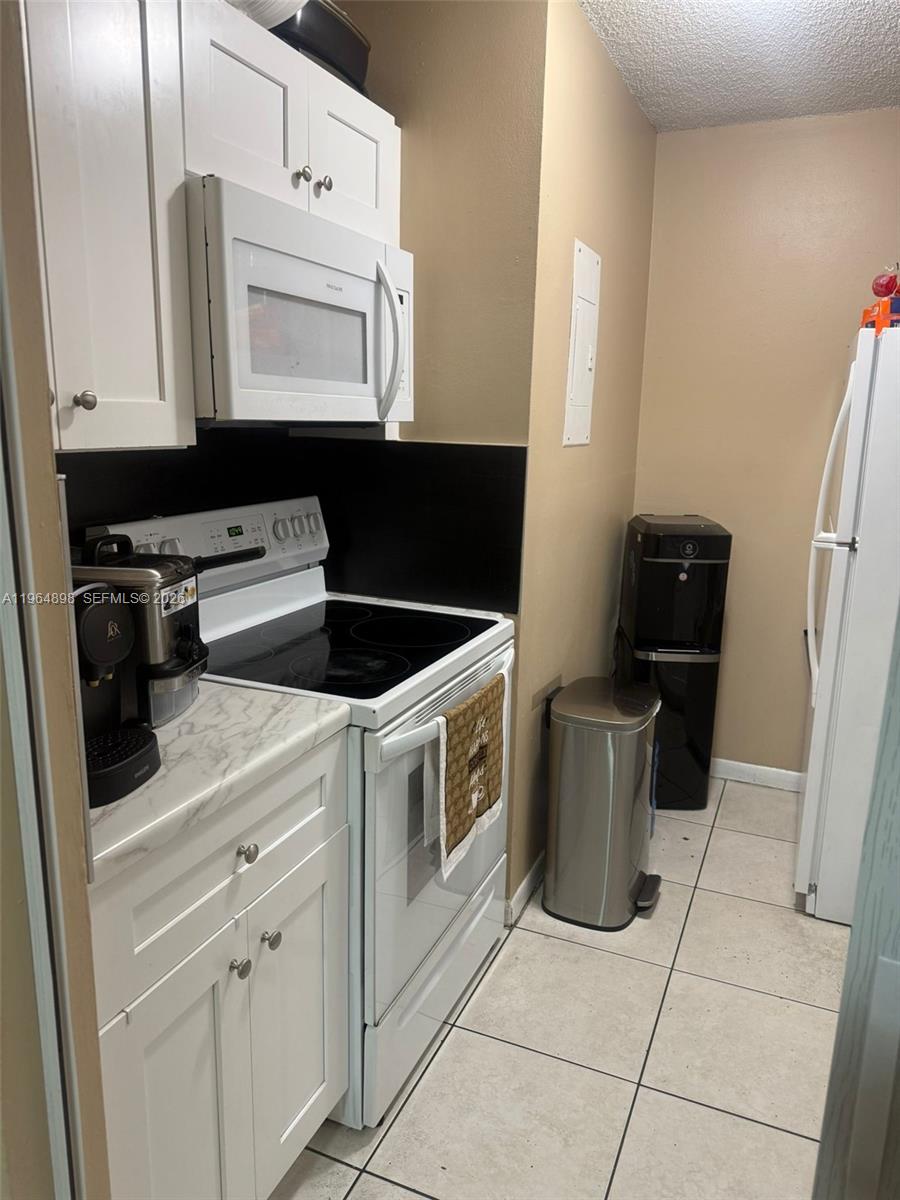 a kitchen with a stove and a microwave