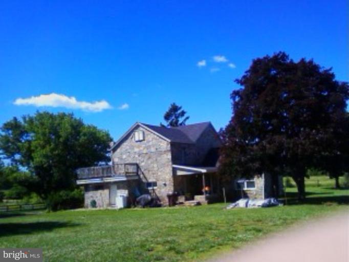 4139 Bullfrog Road Taneytown, MD 21787 - Photo 5 of 7 a view of a big house with a big yard and palm trees