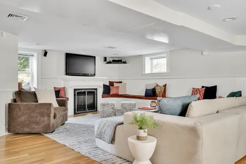 a living room with furniture a fireplace and a flat screen tv