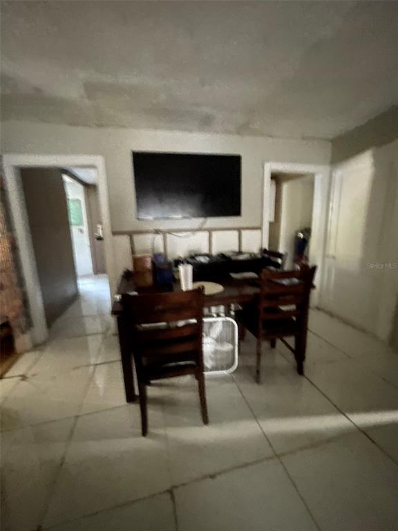 858 35th Avenue South St. Petersburg, FL 33705 - Photo 11 of 20 a living room with furniture and a flat screen tv