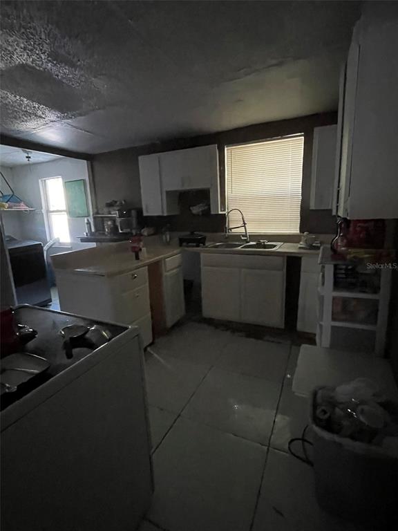 858 35th Avenue South St. Petersburg, FL 33705 - Photo 19 of 20 a kitchen with stainless steel appliances granite countertop a stove a sink and a microwave