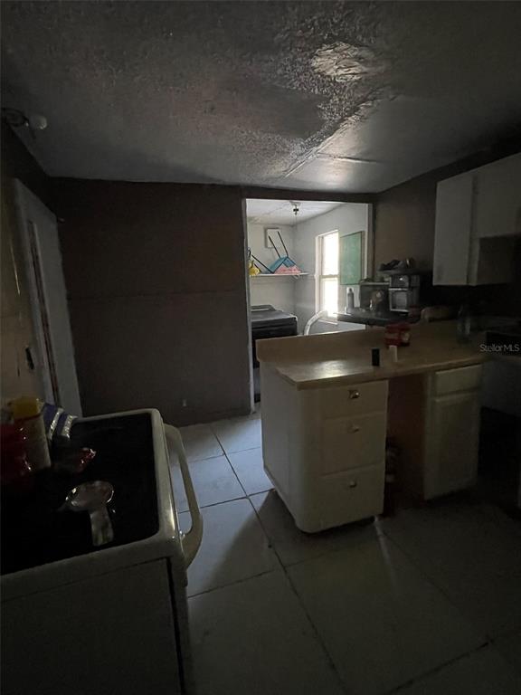 858 35th Avenue South St. Petersburg, FL 33705 - Photo 2 of 20 a kitchen with sink cabinets and window