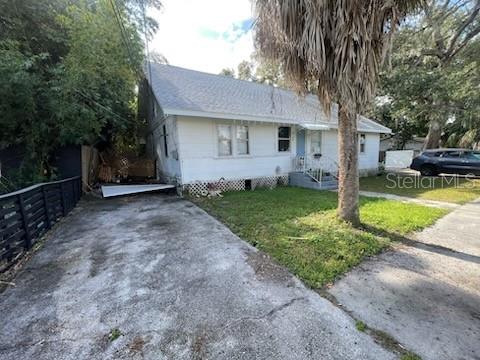 858 35th Avenue South St. Petersburg, FL 33705 - Photo 3 of 20 a front view of a house with a yard and garage