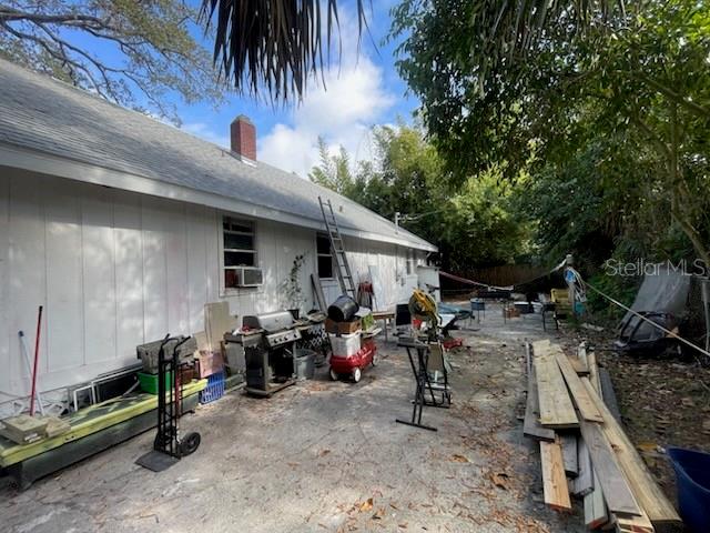 858 35th Avenue South St. Petersburg, FL 33705 - Photo 10 of 20 a view of a patio with table and chairs a barbeque with wooden fence