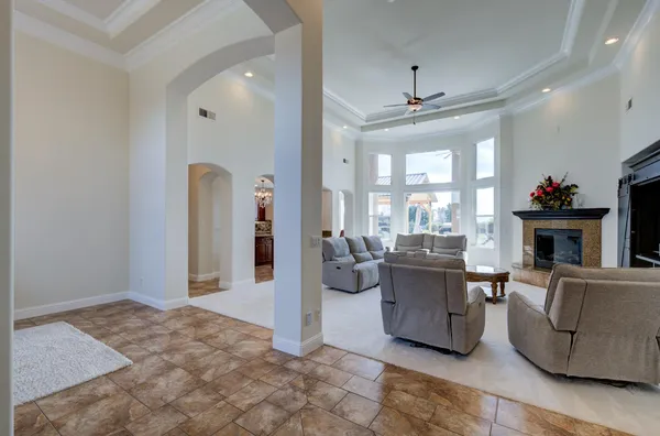a living room with furniture a fireplace and a chandelier