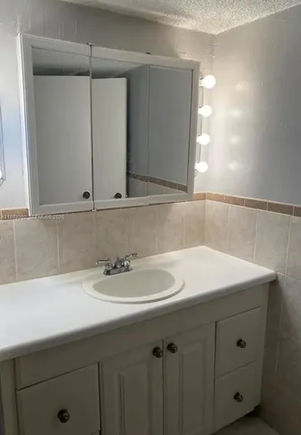 a view of a house with a backyard and sitting area