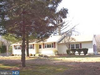 237 Jericho Road Quinton, NJ 08079 - Photo 1 of 3 a front view of a house with a garden and trees
